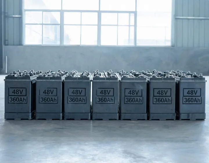 Industrial battery trays labeled with voltage and amp-hour markings